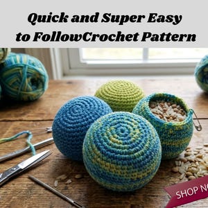 May include: Several spherical crochet items in blue, green, and yellow yarn sit on a wooden surface alongside metal scissors, a crochet hook, and a sewing needle. One sphere is partially open, revealing a filling of rice and lentils inside.