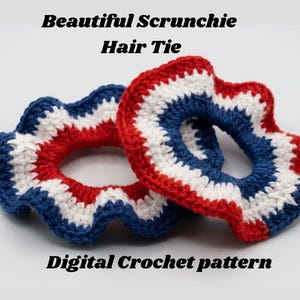 May include: Two crocheted hair scrunchies featuring concentric rings of red, white, and blue yarn. The text "Beautiful Scrunchie Hair Tie" and "Digital Crochet pattern" is displayed above and below the items in a black sans-serif font.