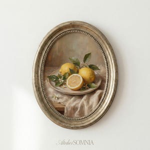 May include: An oval framed still life painting featuring lemons on a plate with leaves and flowers. The painting has a neutral color palette with a gold-colored frame. The text "Atelier SOMNIA" is at the bottom.
