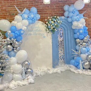 May include: A set of three ceramic mugs with a speckled, matte finish. The mugs are in shades of blue, green, and white. Each mug has a rounded handle and a simple, modern design. Perfect for coffee or tea.