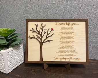 May include: A wooden plaque with a carved tree and a red cardinal. The plaque has a poem about love and loss that reads "I never left you... I watch you every day I am always very near I know deep in your heart You realize I am here I watch you while you sleep In your bed at home I hear you when you speak of me When you are on your own You cannot understand The reason why I have gone But I will never leave you I am there to keep you strong Talk to me I hear you Though you may not see We share an unbroken bond That will always be Death won't keep us apart FOR OUR LOVE IS FOREVER Just remember me in your heart And one day we will be together LIVE YOUR LIFE AND LIVE IT FULL Don't waste a single day Remember I am always with you Every step of the way"