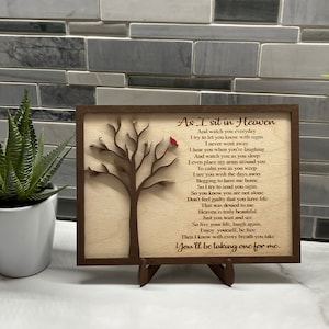 May include: A wooden plaque with a carved tree and a red cardinal. The plaque has a poem about heaven and the afterlife. The text reads: "As I sit in Heaven And watch you everyday I try to let you know with signs I never went away I hear you when you're laughing And watch you as you sleep I even place my arms around you To calm you as you weep I see you wish the days away Begging to have me home So I try to send you signs So you know you are not alone Don't feel guilty that you have life That was denied to me Heaven is truly beautiful Just you wait and see So live your life, laugh again, Enjoy yourself, be free Then I know with every breath you take You'll be taking one for me."