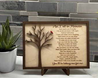 May include: A wooden plaque with a carved tree and a red cardinal. The plaque has a poem about heaven and the afterlife. The text reads: "As I sit in Heaven And watch you everyday I try to let you know with signs I never went away I hear you when you're laughing And watch you as you sleep I even place my arms around you To calm you as you weep I see you wish the days away Begging to have me home So I try to send you signs So you know you are not alone Don't feel guilty that you have life That was denied to me Heaven is truly beautiful Just you wait and see So live your life, laugh again, Enjoy yourself, be free Then I know with every breath you take You'll be taking one for me."