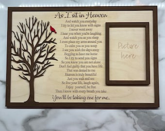May include: A wooden plaque with a cutout tree design and a poem about heaven. The poem reads "As I sit in Heaven...You'll be taking one for me." A smaller frame is included for a picture.