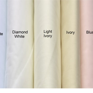 May include: Five fabric swatches in different shades of white and pink. The swatches are labeled "White", "Diamond White", "Light Ivory", "Ivory", and "Blush".