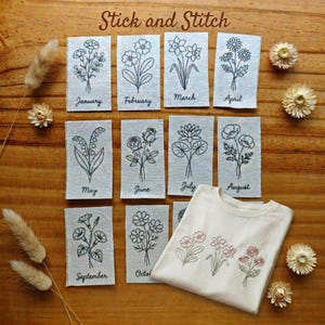 May include: A collection of embroidered floral designs, including a t-shirt with three flower illustrations and twelve fabric tags, each labeled with a month and a different flower outline. The text "Stick and Stitch" is at the top.