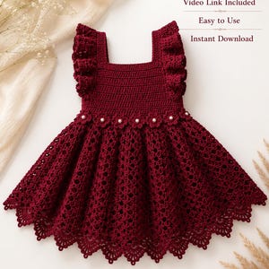 May include: A deep burgundy crochet dress featuring ruffled shoulder straps, a square neckline, and a flared skirt with a scalloped hem. The waist is accented with small white pearl beads. Text reads: Pattern Pages: A to B, Video Link Included, Easy to Use, Instant Download.