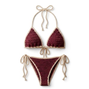 May include: A burgundy crochet bikini set with cream-coloured trim and ties. The triangle top has halter straps that tie at the neck and back. The bottoms have side ties. The set is made of crochet.