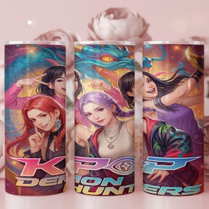 May include: A cylindrical tumbler featuring a vibrant anime-style illustration of three individuals with colorful hair, a large blue dragon, and the text KPOP DEMON HUNTERS in bold, stylized lettering across the bottom of the design.