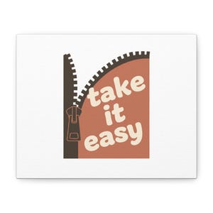 May include: A canvas print featuring a brown zipper partially unzipping to reveal the words "take it easy" in a retro font. The background is white, and the text is in a warm, off-white color.
