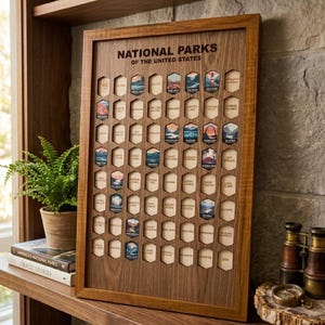 May include: A rectangular wooden National Parks of the United States tracker board featuring a grid of hexagonal cutouts. Each slot contains a small, colorful illustrated emblem of a specific park, with some slots remaining empty for future additions.