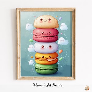 May include: A framed print featuring a stack of colorful macarons with smiling faces. The macarons are in shades of yellow, pink, white, orange, and green, with small cloud and sprinkle details. The text "Moonlight Prints" is at the bottom.
