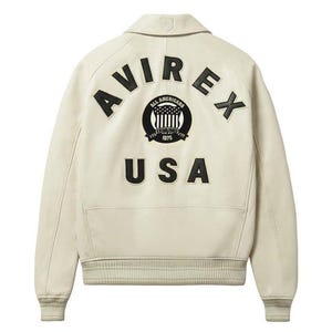 Back view of Avirex Jacket Men leather varsity style jacket featuring large “AVIREX USA” lettering and embroidered All Americans crest logo on the back. This bold Men Avirex Jackets design includes ribbed white striped cuffs and hem, premium leather construction, and classic bomber fit inspired by Avirex heritage style.