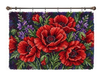 May include: A rectangular latch hook wall hanging featuring a vibrant floral arrangement of large, textured red poppies with dark centers, surrounded by green foliage and small purple flowers, all suspended from a dark metal curtain rod with rings.