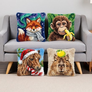 May include: Four decorative throw pillows with animal designs. One pillow features a fox with a scarf against a starry background. Another shows a monkey eating a banana. A pony in a Santa hat and a capybara with a fruit complete the set.