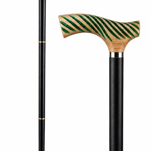 May include: A walking cane featuring a black shaft with two gold-colored bands and a curved handle. The handle is made of light-colored wood with deep, diagonal grooves filled with a vibrant green pigment, accented by a silver-colored collar.