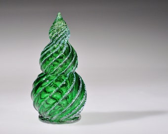 May include: A green glass Christmas tree ornament with a spiral design. The ornament is made of glass and has a shiny finish.