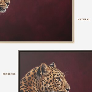 May include: Two framed wall art prints featuring a leopard in profile against a deep burgundy background. One print is encased in a light-colored natural wood frame labeled NATURAL, and the other is in a dark espresso frame labeled ESPRESSO.