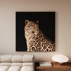 May include: A square wall art print featuring a detailed illustration of a leopard with tan fur and black spots, set against a solid black background. The leopard is depicted in profile, looking toward the right side of the frame.