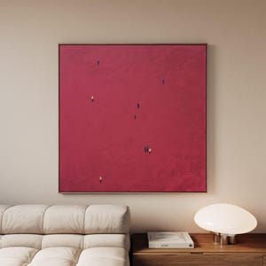 May include: A square canvas painting featuring a solid, textured deep magenta background. Small, minimalist figures in various colors are scattered across the surface, appearing as tiny silhouettes walking or standing in an expansive, open space.