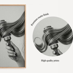 May include: Black and white print of a round hairbrush with long, wavy hair. The brush is held in a hand. The image is in a wooden frame. Text on the right says "Premium matte finish" and "High quality prints."