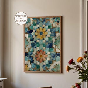 May include: A framed art print featuring a geometric floral design in shades of blue, teal, yellow, and peach. The artwork has a mosaic tile appearance and is set within a natural wood frame. The text "PRINTED & SHIPPED" is in a white circle.