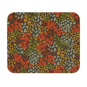 May include: A rectangular floral pattern featuring a dark brown background with a repeating design of orange, yellow, and blue flowers, along with green leaves. The design has rounded corners.