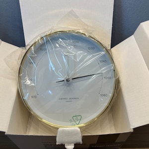 May include: A set of three ceramic mugs with a speckled, matte finish. The mugs are in shades of cream, light gray, and dark gray. Each mug has a simple, minimalist design, perfect for coffee or tea.