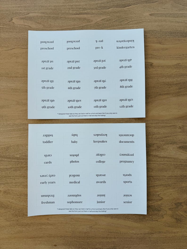 May include: Two white sheets of paper with black text. Each sheet has a grid of 12 squares. Each square contains a word related to age or life stages. The words on the top sheet are: preschool, pre-k, kindergarten, 1st grade, 2nd grade, 3rd grade, 4th grade, 5th grade, 6th grade, 7th grade, 8th grade, 9th grade, 10th grade, 11th grade, and 12th grade. The words on the bottom sheet are: toddler, baby, keepsakes, documents, cards, photos, college, pregnancy, early years, medical, awards, sports, freshman, sophomore, junior, and senior.