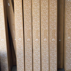 May include: A stack of cardboard boxes with a white floral pattern and the text "RUBY RYE CO" printed on them.