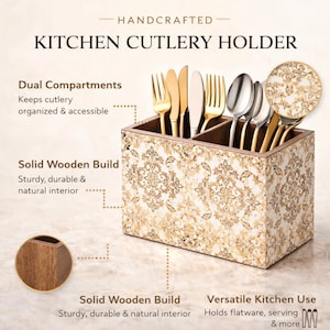 May include: A handcrafted kitchen cutlery holder with dual compartments. The holder is made of solid wood and features a decorative floral pattern in shades of gold and cream. It holds various utensils, including forks, knives, and spoons.