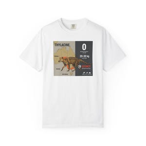 May include: White t-shirt featuring a graphic of a Thylacine, also known as the Tasmanian tiger, with a map of Australia. The graphic includes the text "THYLACINE", "0", "20-30 kg", and "EXTINCT".