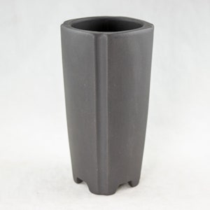 May include: A dark gray ceramic planter with a square shape and a slightly flared top. The planter has a textured surface and a base with four points.