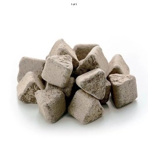 May include: A pile of small, triangular, light brown, irregularly shaped, porous stones.
