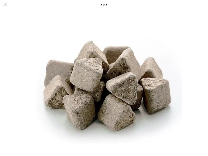 May include: A pile of small, triangular, light brown, irregularly shaped, porous stones.
