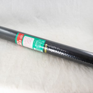 May include: A black plastic mesh roll wrapped in clear plastic. The packaging has Japanese text that reads "防虫ネット" which translates to "insect net".