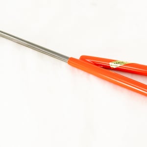 May include: A red handled hook tool with a metal hook. The handle is made of a flexible plastic material and has a gold label that says "MADE IN JAPAN".