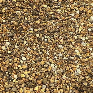 May include: A close-up of a mixture of small, brown, tan, and white pebbles. The pebbles are various sizes and shapes, creating a textured surface.