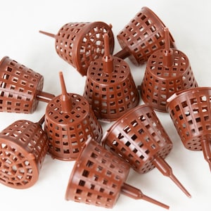 May include: A group of ten brown plastic plant pots with a grid pattern and a pointed bottom. The pots are designed for hydroponic gardening.
