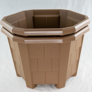 May include: A brown, octagonal planter with a textured, shingle-like design. The planter has a double-rimmed top and is made of a durable material. It is designed for outdoor or indoor use and has a sturdy base.
