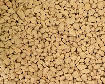May include: A close-up image of a pile of small, light brown, irregularly shaped stones. The stones are all about the same size and have a rough, textured surface.