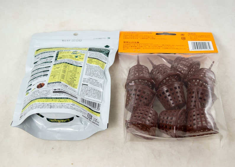 May include: Two packages of gardening supplies. One package contains brown plastic plant pots with a grid pattern. The other package contains a bag of fertilizer with Japanese text and a barcode.