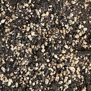 May include: Close-up of a soil mixture with small, light brown pebbles and dark brown soil.