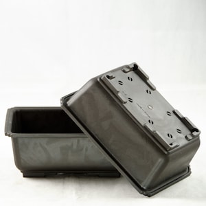 May include: A black plastic rectangular planter with drainage holes and the text "Made in China" on the bottom.