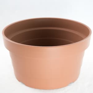 May include: A terracotta colored plastic plant pot. The pot is round and has a smooth, slightly textured surface.
