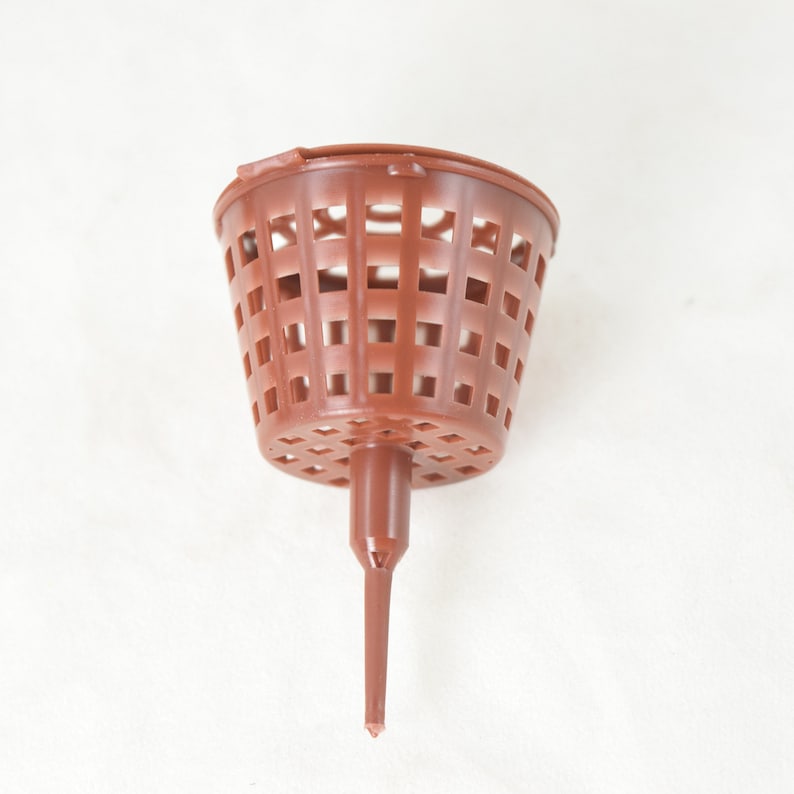 May include: A brown plastic net pot with a pointed base. The pot is designed for hydroponic gardening.