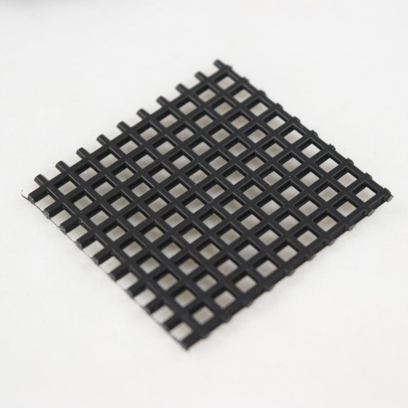 May include: A black plastic square mesh grid.
