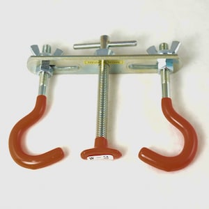 May include: A metal tool with two hooks and a screw mechanism. The hooks are red and the screw is silver. The tool is labeled "MADE IN JAPAN" and "W-2".