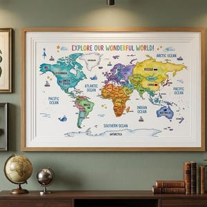 May include: A colorful world map print with the text "EXPLORE OUR WONDERFUL WORLD!" is framed and displayed on a green wall, alongside other framed art pieces. The map is surrounded by other framed art pieces, including a botanical print and a framed compass.