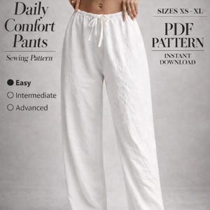 May include: White linen Daily Comfort Pants sewing pattern. The image shows a pair of white pants with a drawstring waist. The text on the image says "PDF Pattern, Instant Download" and "Sizes XS-XL". The sewing pattern difficulty levels are Easy, Intermediate, and Advanced.
